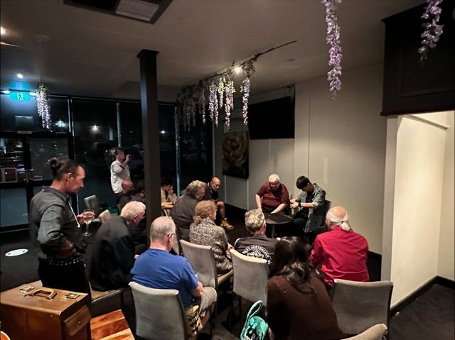 Members gather around a close-up table at the October 2023 meeting