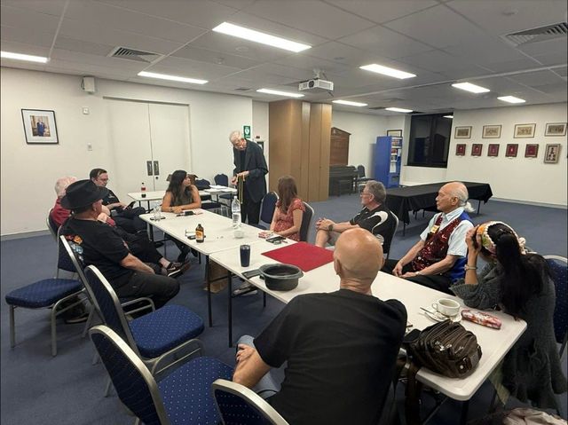 A member performs a rope effect for members around the tables at the November 2025 meeting
