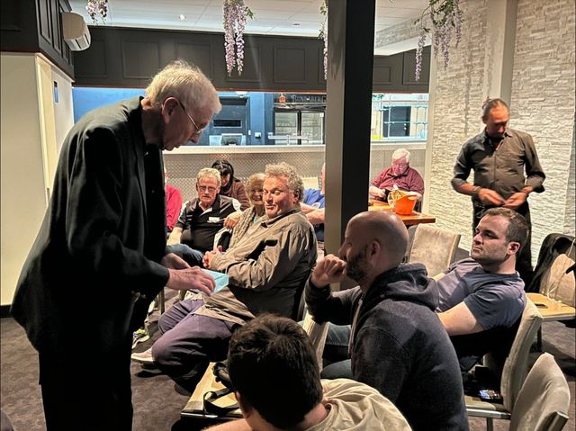 A member performing a close-up effect for seated members at the October 2023 meeting