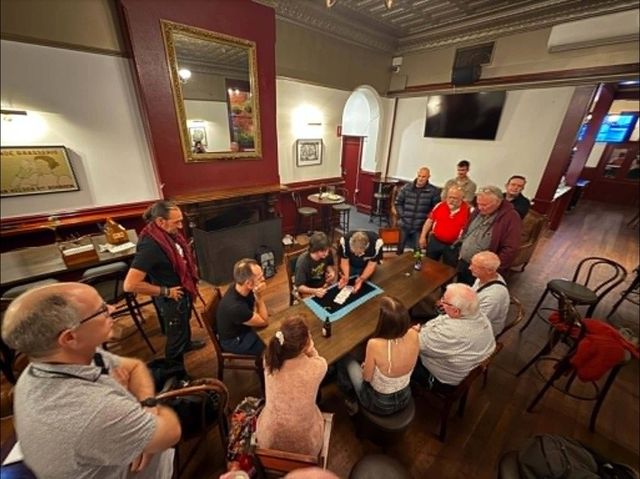 Members gather around a close-up mat in the Le Roi room after the 2026 AGM