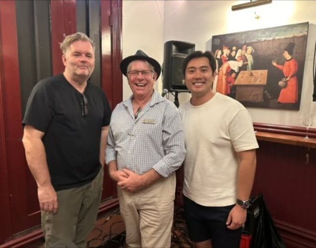 Vince Haines with two attendees in the Le Roi room on lecture night